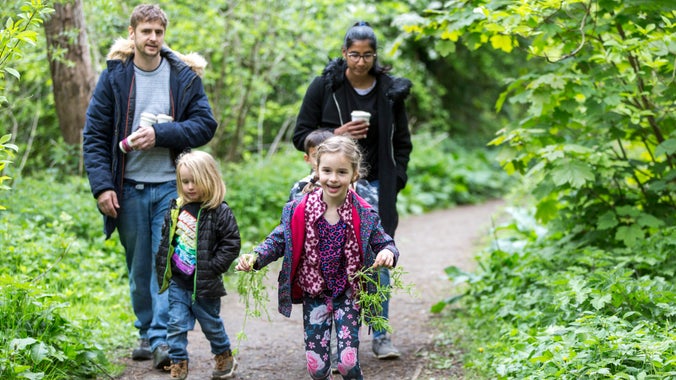 Family visitors walking in woodland